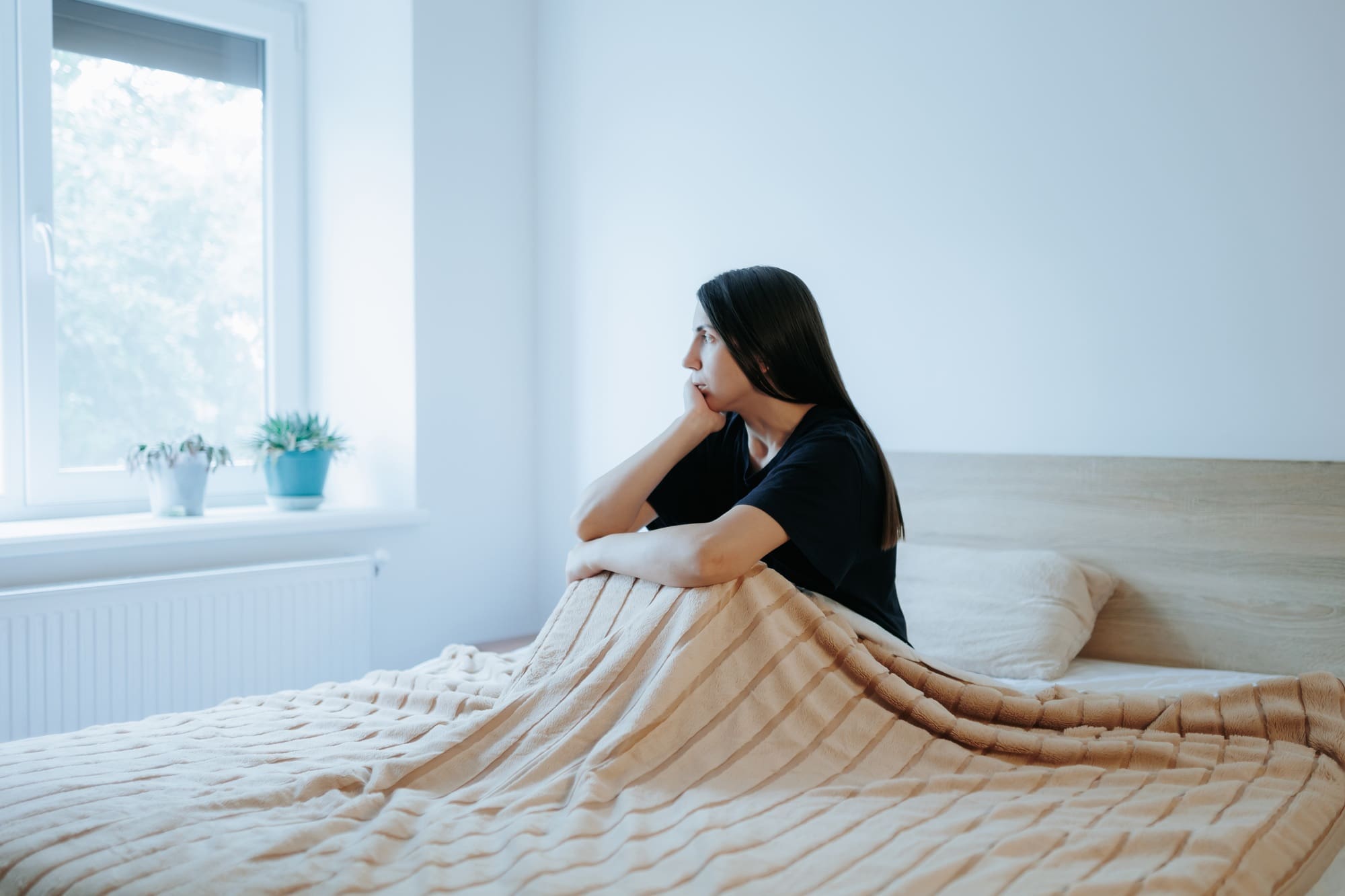 cognitive behavioral treatment therapy header with woman sitting in a bright bedroom